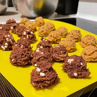 Hot Choc It Up and OG protein cookie dough on a silicone yellow mat